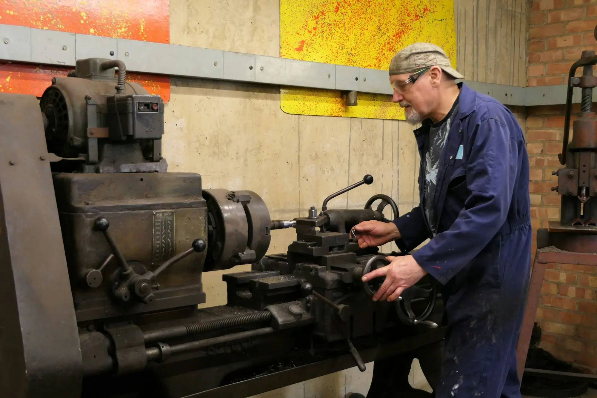 Engineer operating a lathe in a light engineering workshop in Dunedin